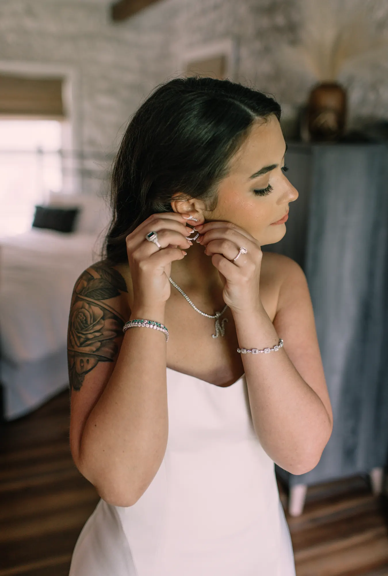 A bride fastening her earrings on her wedding day