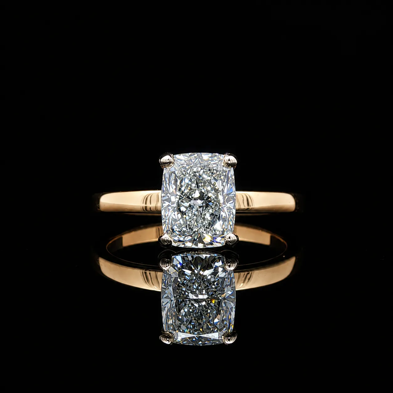 A cushion cut diamond solitaire on a yellow gold band