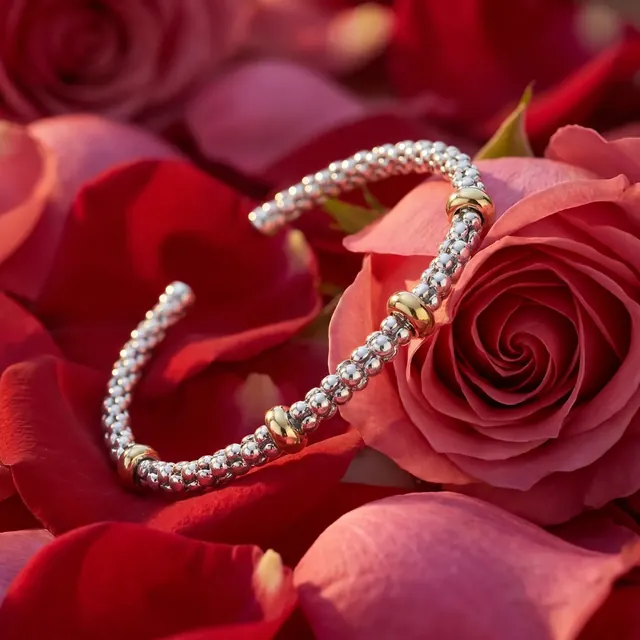 A diamond bypass bangle on red rose petals