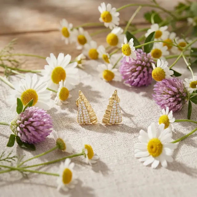 Yellow gold pave fan earrings among daisies and clover