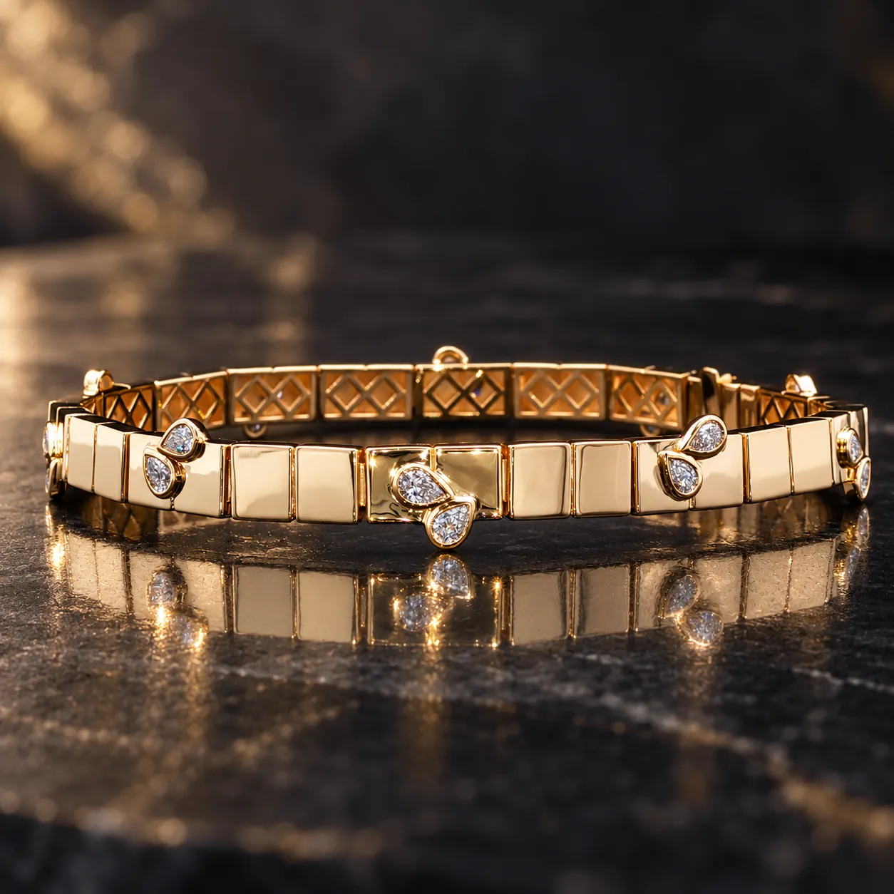 A yellow gold link bracelet set with pairs of pear diamonds