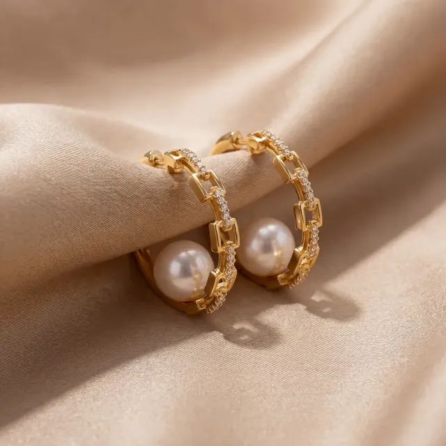 Yellow gold hoops with pearls on cream satin